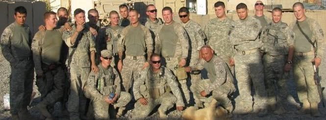 A squad posed together on deployment